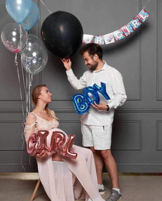 full-length-image-young-excited-couple-blowing-up-surprise-balloon-gender-reveal-party-indoors full-length-image-young-excited-couple-blowing-up-surprise-balloon-gender-reveal-party-indoors